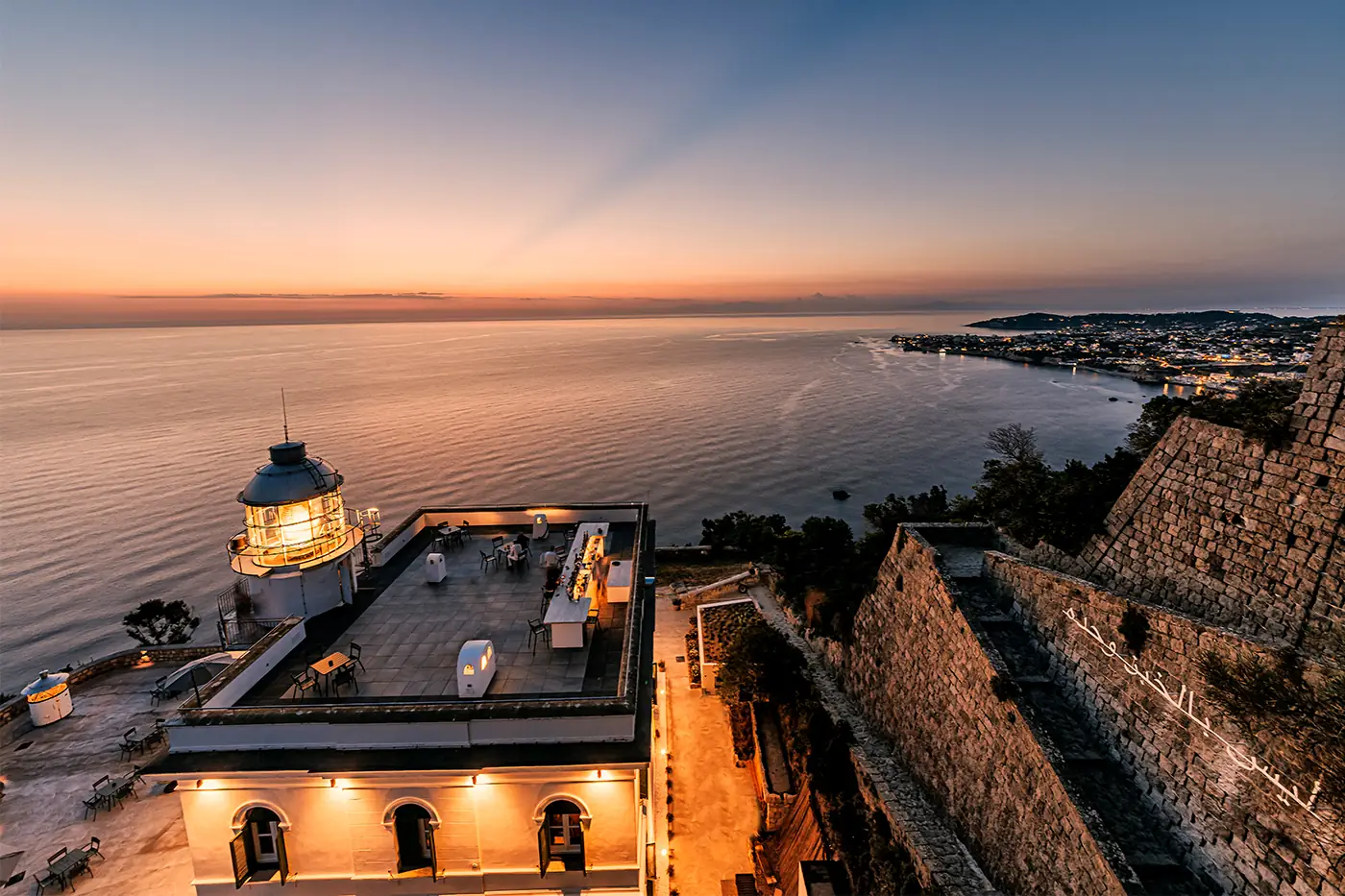 Il Faro di Punta Imperatore a Ischia al tramonto, ripreso dal drone