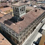 Il palazzo e la torre-belvedere fra i tetti della città, dal drone