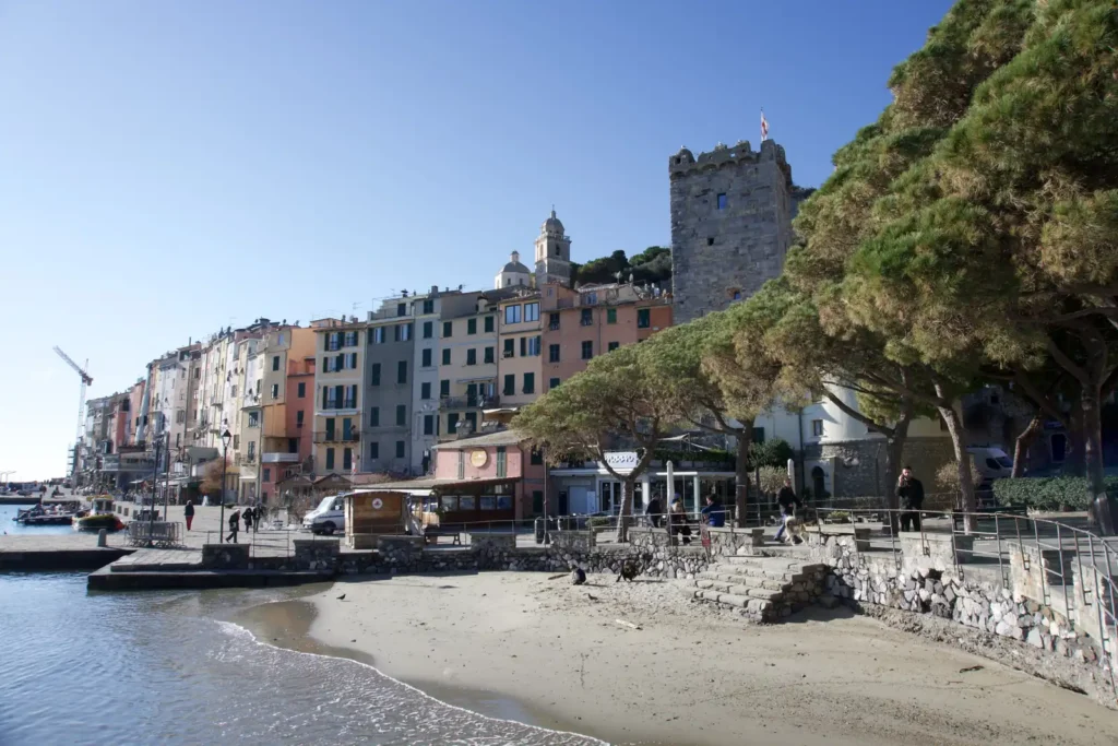 La spiaggia sotto il borgo con la Torre Capitolare e le case sul porto
